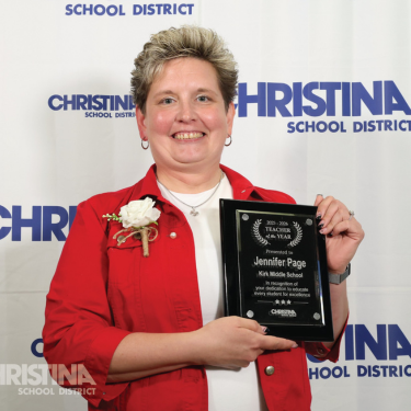 Photo of Jennifer Page Kirk MS 2025-2026 Teacher of the Year holding plaque